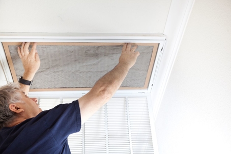 Man removing air filter