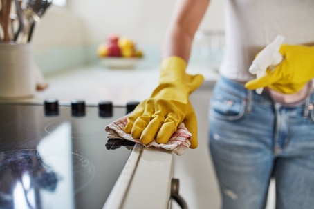 Woman wiping down stovetop