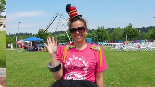 CARES Sensory Circus 2026 recap event host waving at the camera in a pink CARES shirt and circus ringmaster hat